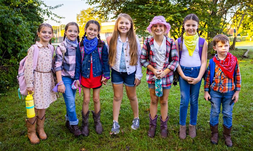 Students wearing western wear walk to school